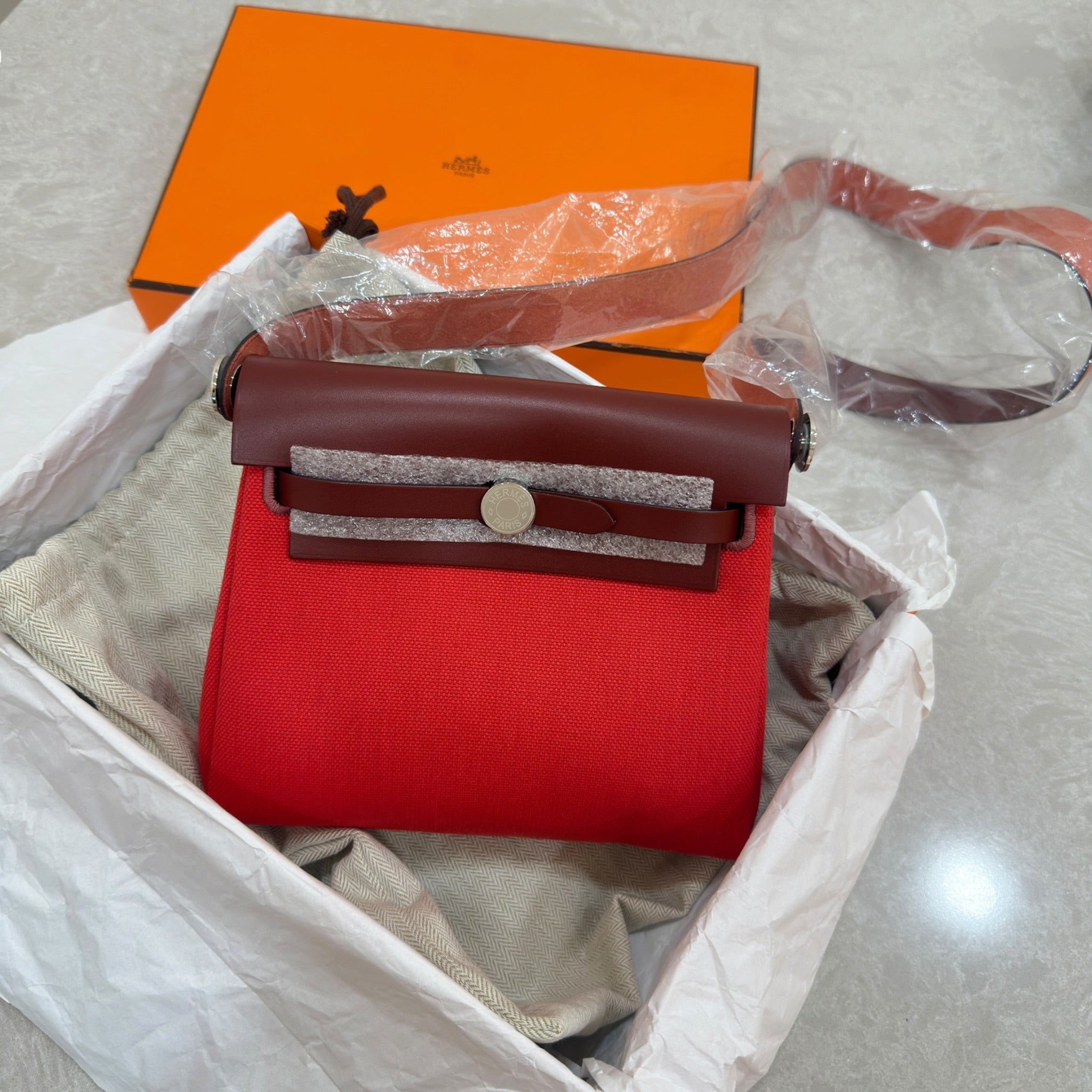 Hermès Retourne 20 Rouge Herbag Military Canvas and Vache Hunter Leather with a Palladium-Plated (2025)